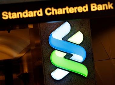 A logo of Standard Chartered is displayed at its main branch in Hong Kong, China August 1, 2017. REUTERS/Bobby Yip  A logo of Standard Chartered is displayed at its main branch in Hong Kong, China August 1, 2017. REUTERS/Bobby Yip