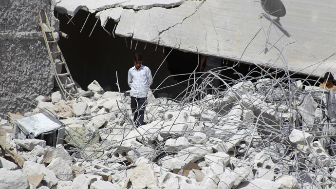 A resident walks upon the debris of buildings which were damaged in what activists say was one of Tuesday's U.S. air strikes in Kfredrian, Idlib province September 24, 2014. (Reuters/Ammar Abdullah)