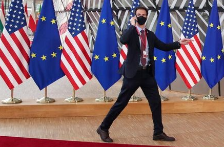 A security guard walks near EU and U.S. flags, before the EU-US summit, in Brussels, Belgium June 15, 2021. REUTERS/Yves Herman A security guard walks near EU and U.S. flags, before the EU-US summit, in Brussels, Belgium June 15, 2021. REUTERS/Yves Herman