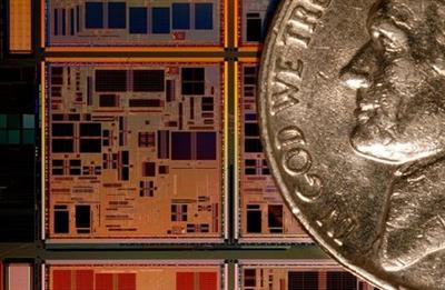 A custom made PowerPC microprocessor seen next to a nickel (a U.S. five cent coin) at the IBM 300 mm Manufacturing Plant in East Fishkill, New York March 24, 2004. This state of the art facility has become one of the largest outsource manufacturers of semiconductors. REUTERS/Chip East CME/JDP