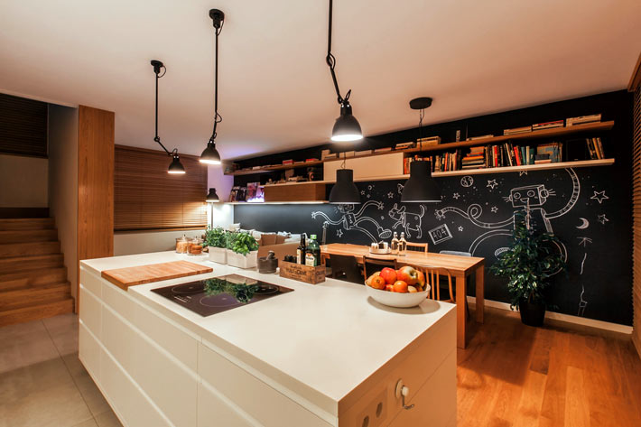 Современный дизайн кухни со столовой зоной и черной стеной фото