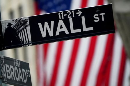 FILE PHOTO: A Wall Street sign outside the New York Stock Exchange in New York City, New York, U.S., October 2, 2020. REUTERS/Carlo Allegri/File Photo