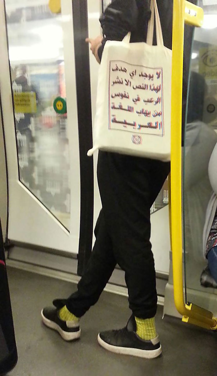 Meanwhile In A Berlin Metro. The Text On The Bag Reads:  