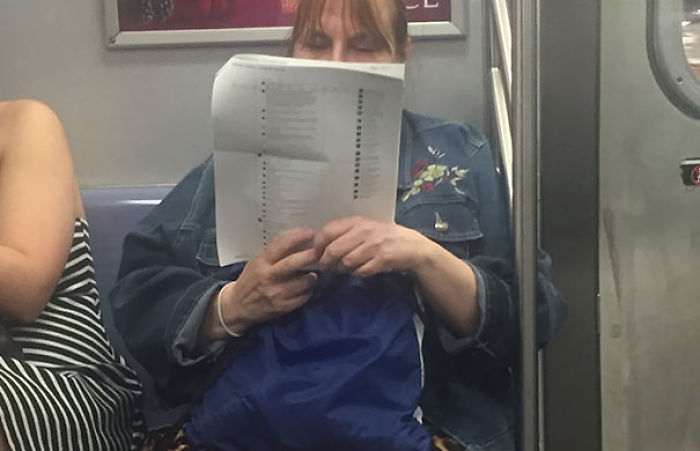 A Woman On The Subway Printed Out 15 Pages Of Facebook Posts And Is Just Reading The Comments