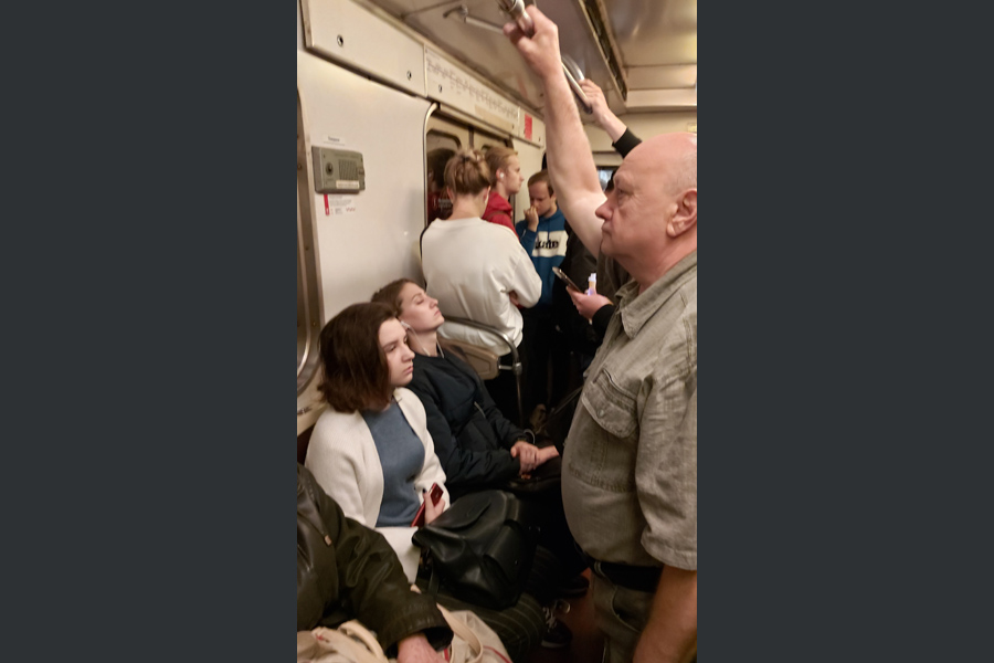 Man-Stand-Girl-Seat-Metro Man-Stand-Girl-Seat-Metro