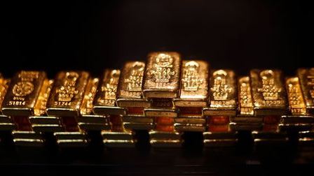 Gold bars are stacked at a safe deposit room of the ProAurum gold house in Munich March 6, 2014. Gold was flat on Thursday as diplomatic efforts to cool the Ukraine crisis depressed demand for assets seen as safe, but the metal found support above $1,330 an ounce from weak U.S. economic data and ahead of a key employment report. REUTERS/Michael Dalder(GERMANY - Tags: BUSINESS COMMODITIES SOCIETY) Gold bars are stacked at a safe deposit room of the ProAurum gold house in Munich March 6, 2014. Gold was flat on Thursday as diplomatic efforts to cool the Ukraine crisis depressed demand for assets seen as safe, but the metal found support above $1,330 an ounce from weak U.S. economic data and ahead of a key employment report. REUTERS/Michael Dalder(GERMANY - Tags: BUSINESS COMMODITIES SOCIETY)