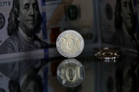 Kazakh 200 tenge coins are pictured in front of a U.S. 100 dollar banknote in this illustration taken March 10, 2020. REUTERS/Pavel Mikheyev/Illustration Kazakh 200 tenge coins are pictured in front of a U.S. 100 dollar banknote in this illustration taken March 10, 2020. REUTERS/Pavel Mikheyev/Illustration