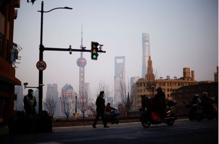 People walk on a street, in front of Lujiazui financial district of Pudong, in Shanghai, China March 4, 2021. Picture taken March 4, 2021. REUTERS/Aly Song People walk on a street, in front of Lujiazui financial district of Pudong, in Shanghai, China March 4, 2021. Picture taken March 4, 2021. REUTERS/Aly Song