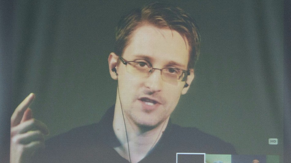 Edward Snowden talks with journalists during a video news conference.