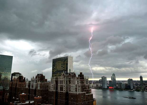 With the United Nations and Tudor City in the foreground, lightning strikes in the sky over the East River  as a major storm approaches New York City on July 2, 2014.