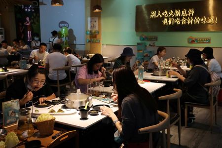FILE PHOTO: People dine at a hotpot restaurant in Sanya, Hainan province, China November 26, 2020. REUTERS/Tingshu Wang  FILE PHOTO: People dine at a hotpot restaurant in Sanya, Hainan province, China November 26, 2020. REUTERS/Tingshu Wang