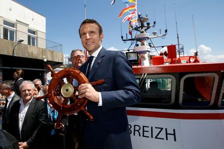 French President Emmanuel Macron receives a gift on a trawler as he visits the harbour of Lorient, France, June 1, 2017. REUTERS/Stephane Mahe French President Emmanuel Macron receives a gift on a trawler as he visits the harbour of Lorient, France, June 1, 2017. REUTERS/Stephane Mahe
