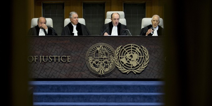 Presiding judge Peter Tomka, second right, of Slovakia starts reading the World Court's decision in The Hague, Netherlands Tuesday, Feb. 3, 2015 as the International Court of Justice, the United Nations' highest court, is ruling on whether Croatia and Serbia committed genocide during the wars sparked by the breakup off the former Yugoslavia in the 1990s. Croatia has accused Serbia of genocide early in the wars and Serbia in turn claims that Croat forces were responsible for genocide in a 1995 campaign to retake territory held by rebel Serbs. Other judges, from left, are; Ronny Abraham of France, Bernardo Sepulveda-Amor of Mexico, Tomka and Hisashi Owada of Japan. (AP Photo/Peter Dejong)