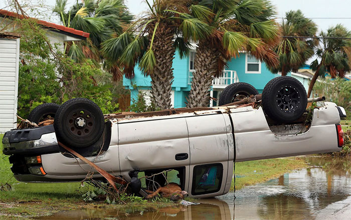 A Dead Dog Lies Out Of The Passenger Window Of An Overturned Pickup Truck After Hurricane Harvey Landed In The Coast Bend Area In Port Aransa