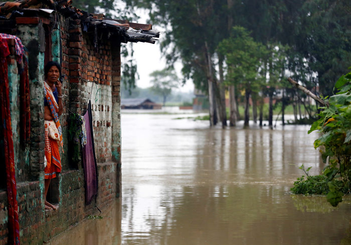 A Woman Looks Out From Her House In Janakpur, Nepal