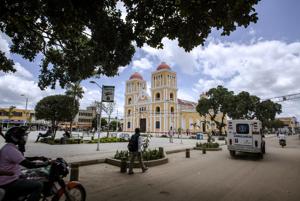 An ambulance passes by the main square of Carmen de …