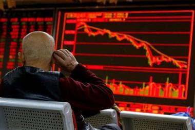 FILE PHOTO: An investor sits in front of a board showing stock information at a brokerage office in Beijing, China, December 7, 2018. REUTERS/Thomas Peter/File Photo FILE PHOTO: An investor sits in front of a board showing stock information at a brokerage office in Beijing, China, December 7, 2018. REUTERS/Thomas Peter/File Photo