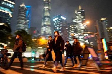People wearing protective masks walk on a street, following new cases of the coronavirus disease (COVID-19), in Shanghai, China, December 16, 2021. REUTERS/Aly Song People wearing protective masks walk on a street, following new cases of the coronavirus disease (COVID-19), in Shanghai, China, December 16, 2021. REUTERS/Aly Song