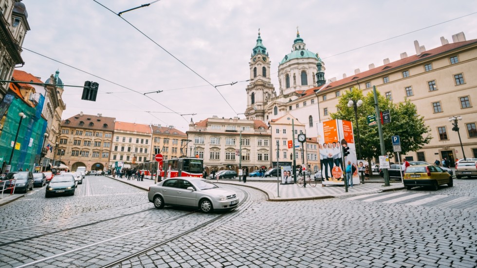 Car cross the tram tracks on the street Malostranske namesti in