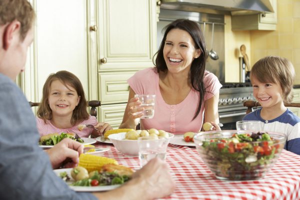 Family Eating Meal Together In Kitchen