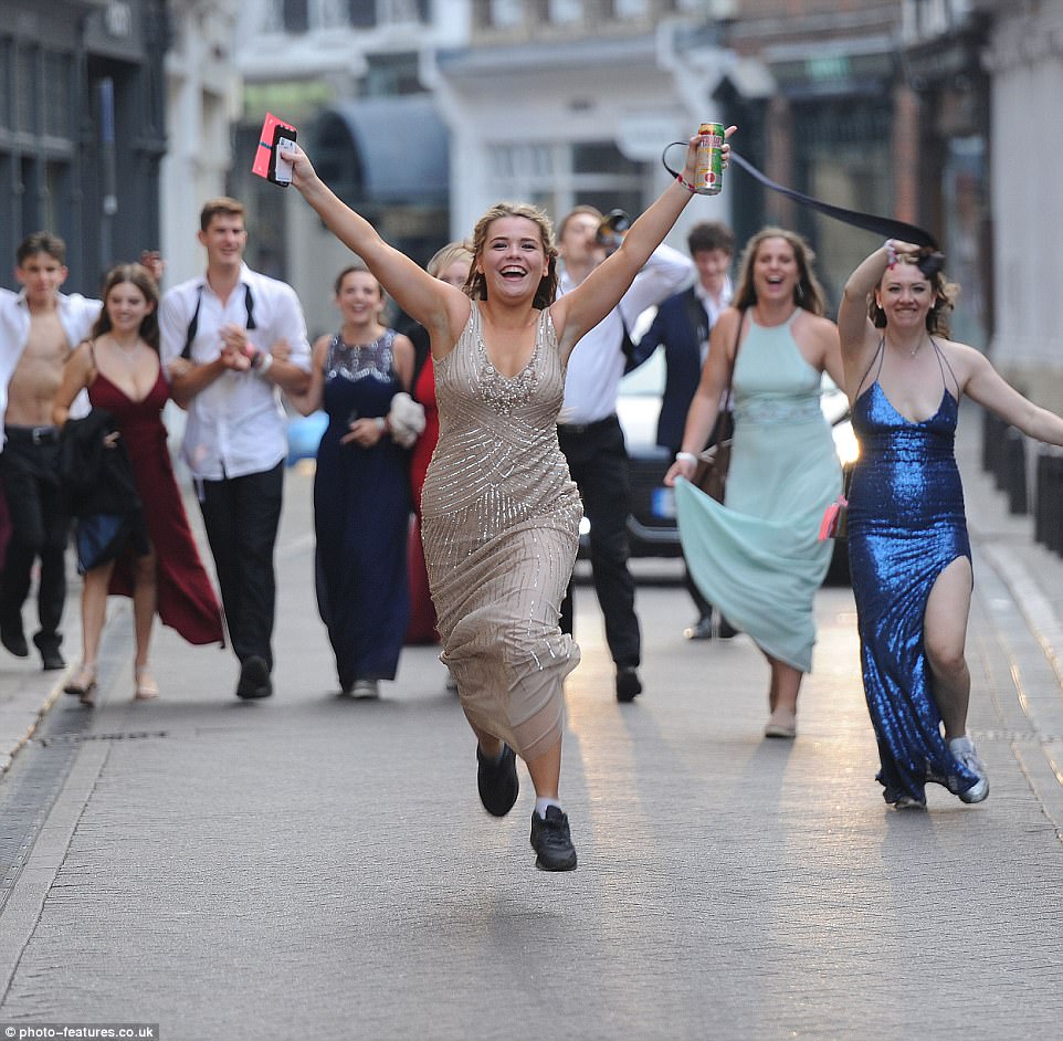 Clutching a can of Desperados tequila, one female reveller looks set to continue the party as she charges through the streets
