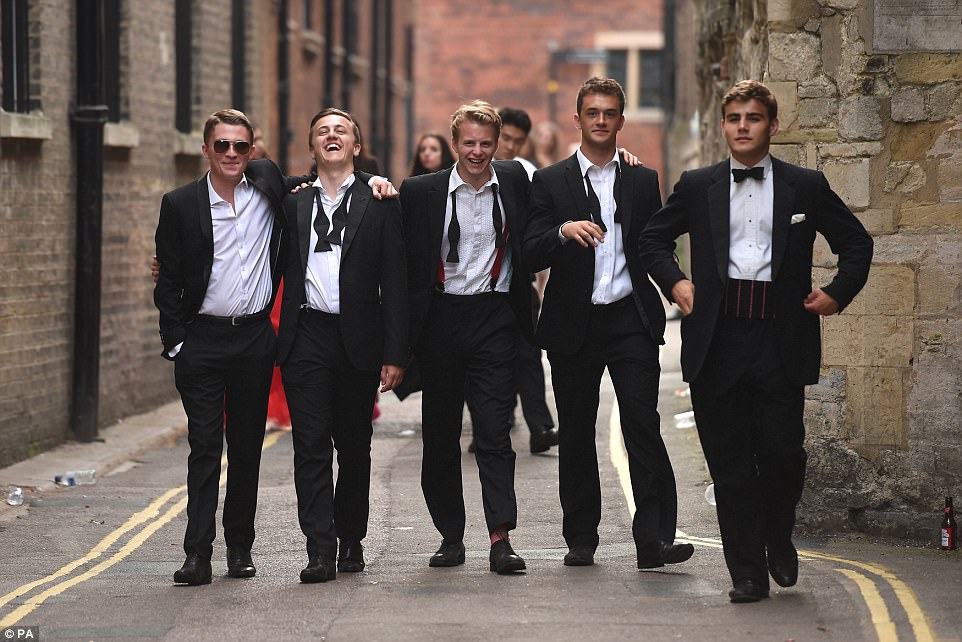 Men in black: A group of smartly-dressed friends make their way back to their student halls after partying all night