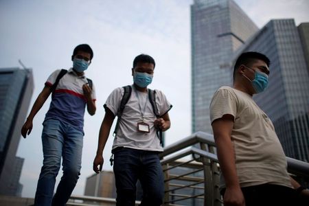 Men wearing protective masks walk on a bridge, following new cases of the coronavirus disease (COVID-19), in Shanghai, China August 23, 2021. REUTERS/Aly Song Men wearing protective masks walk on a bridge, following new cases of the coronavirus disease (COVID-19), in Shanghai, China August 23, 2021. REUTERS/Aly Song
