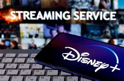 A smartphone with displayed "Disney" logo is seen on the keyboard in front of displayed "Streaming service" words in this illustration taken March 24, 2020. REUTERS/Dado Ruvic A smartphone with displayed "Disney" logo is seen on the keyboard in front of displayed "Streaming service" words in this illustration taken March 24, 2020. REUTERS/Dado Ruvic