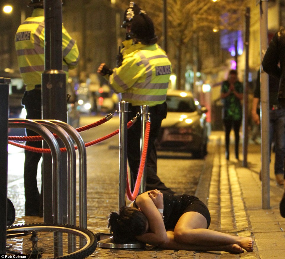 Catching some sleep: This woman decided to lie in the gutter on Prince of Wales Road in Norwich on New Year's Eve