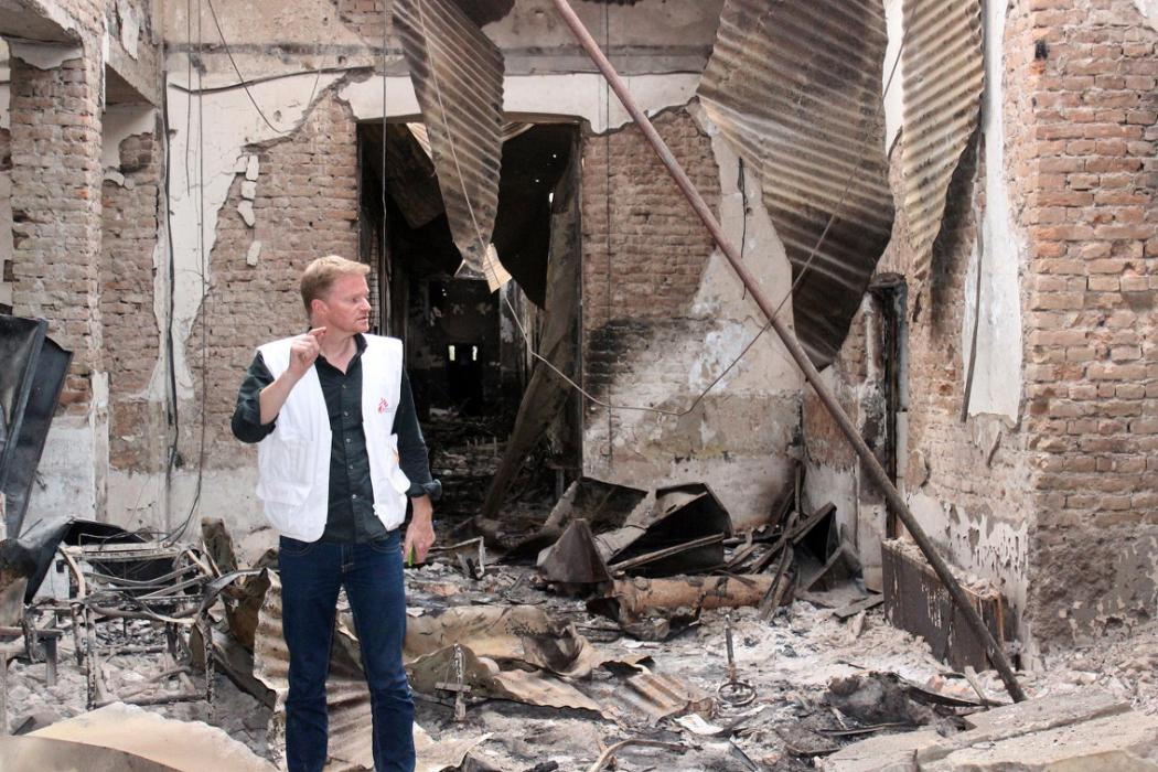 In this Friday, Oct. 16, 2015 photo, Christopher Stokes, the general director of the medical charity, Doctors Without Borders, which is also known by its French abbreviation MSF, stands amid the charred remains of the organization's hospital, after it was hit by a U.S. airstrike in Kunduz, Afghanistan. Stokes says the extensive, quite precise destruction of the bombing raid casts doubt on American military assertions that it was a mistake. (Najim Rahim via AP)