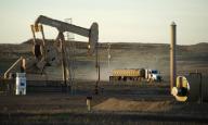 Грузовик проезжает мимо станка-качалки в Северной Дакоте 1 ноября 2014 года. Министр нефтяной промышленности Кувейта во вторник подтвердил, что ОПЕК в октябре обсудит предложенную Венесуэлой новую стратегию повышения цен, предусматривающую нижнюю границу в $70 за баррель. REUTERS/Andrew Cullen
