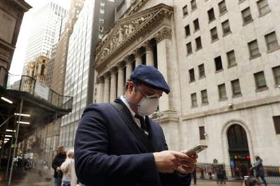 FILE PHOTO: A man walks past the New York Stock Exchange on the corner of Wall and Broad streets in New York City, New York, U.S., March 13, 2020. REUTERS/Lucas Jackson/File Photo FILE PHOTO: A man walks past the New York Stock Exchange on the corner of Wall and Broad streets in New York City, New York, U.S., March 13, 2020. REUTERS/Lucas Jackson/File Photo