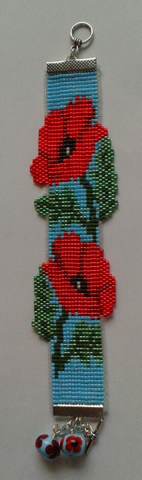 A loomed poppy bracelet by Bella Gray - inspired by Erin Simonetti's Prosperity Dragon Cuff and created following the project in Issue 36 of Bead.