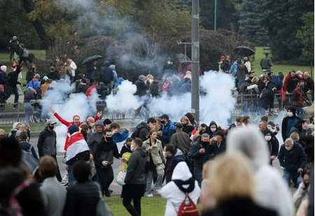Demonstrators react as a stun grenade explodes during an opposition rally to reject the presidential election results in Minsk, Belarus October 11, 2020. BelaPAN via REUTERS Demonstrators react as a stun grenade explodes during an opposition rally to reject the presidential election results in Minsk, Belarus October 11, 2020. BelaPAN via REUTERS