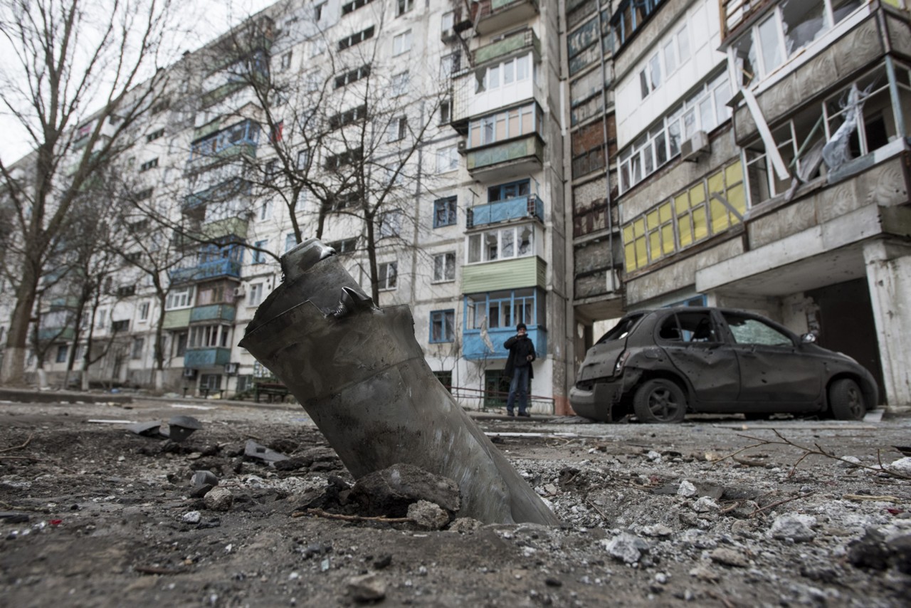A piece of an exploded Grad missile is photographed outside an apartment building in Vostochniy, district of Mariupol, Eastern Ukraine, Sunday, Jan. 25, 2015. Indiscriminate rocket fire slammed into a market, schools, homes and shops Saturday in Ukraine's southeastern city of Mariupol, killing at least 30 people, authorities said. The Ukrainian president called the blitz a terrorist attack and NATO and the U.S. demanded that Russia stop supporting the rebels. (AP Photo/Evgeniy Maloletka)