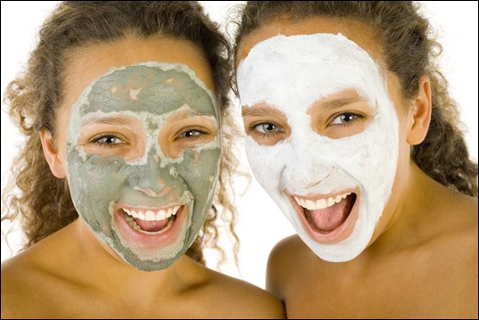 Happy girls with puryfying masks Happy girls with puryfying masks
