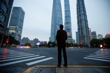 A man stands at a crossroads in Lujiazui financial district in Pudong, Shanghai, on the day of the opening session of the National People's Congress (NPC), China March 5, 2021. REUTERS/Aly Song A man stands at a crossroads in Lujiazui financial district in Pudong, Shanghai, on the day of the opening session of the National People's Congress (NPC), China March 5, 2021. REUTERS/Aly Song