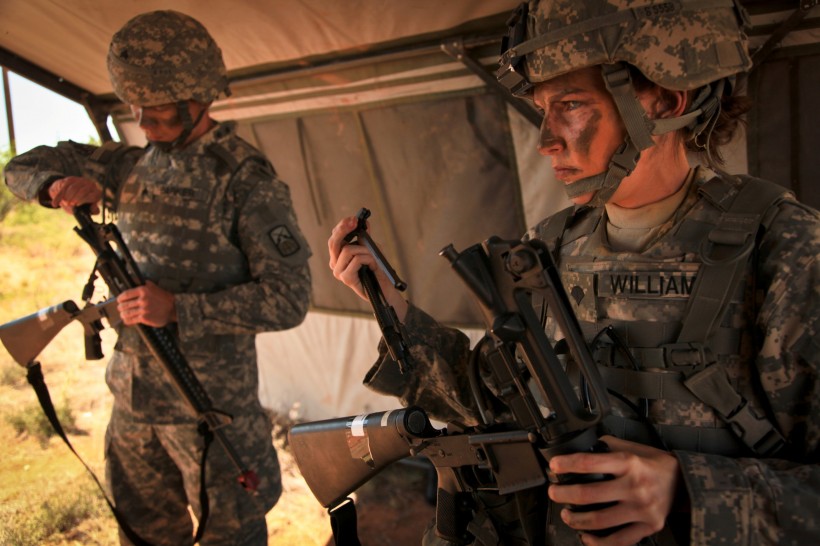 U.S. Army Sgt. Phillip Barker (left), assigned to the 160th Signal Brigade, and Spc. Brittany Williams (right), assigned to the 7th Signal Command, prepare to reassemble their rifles for the react to contact lane at Fort Huachuca, Ariz., on 15 June, 2010.  The react to contact lane is one of six lanes of the warrior task training drills conducted for the Non-Commissioned Officer / Soldier of the Year competition.   (U.S. Army photo by Spc. Canaan Radcliffe/Not Released)