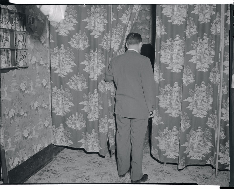 A detective peers into a tearoom in 1959.
