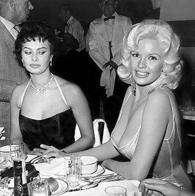       .  / Sophia Loren looks at Jayne Mansfield's breast. Photo