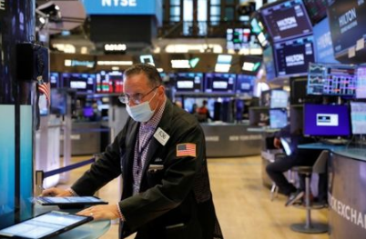 FILE PHOTO: A trader works on the trading floor at the New York Stock Exchange (NYSE) in Manhattan, New York City, U.S., August 9, 2021. REUTERS/Andrew Kelly FILE PHOTO: A trader works on the trading floor at the New York Stock Exchange (NYSE) in Manhattan, New York City, U.S., August 9, 2021. REUTERS/Andrew Kelly