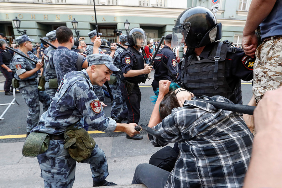 A serviceman of the Russian National Guard beats a protester A serviceman of the Russian National Guard beats a protester