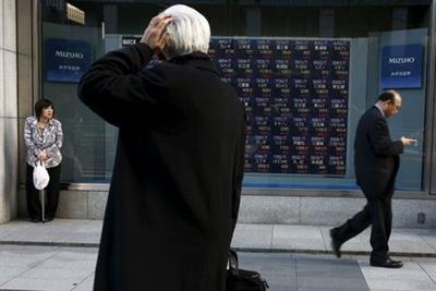 A man looks at an electronic board showing market indices outside a brokerage in Tokyo, Japan, March 2, 2016. Japan's Nikkei surged to a more than three-week high on Wednesday as the dollar rose against the yen after strong U.S. factory and construction data, giving exporters a boost and lifting the overall market. REUTERS/Thomas Peter A man looks at an electronic board showing market indices outside a brokerage in Tokyo, Japan, March 2, 2016. Japan's Nikkei surged to a more than three-week high on Wednesday as the dollar rose against the yen after strong U.S. factory and construction data, giving exporters a boost and lifting the overall market. REUTERS/Thomas Peter