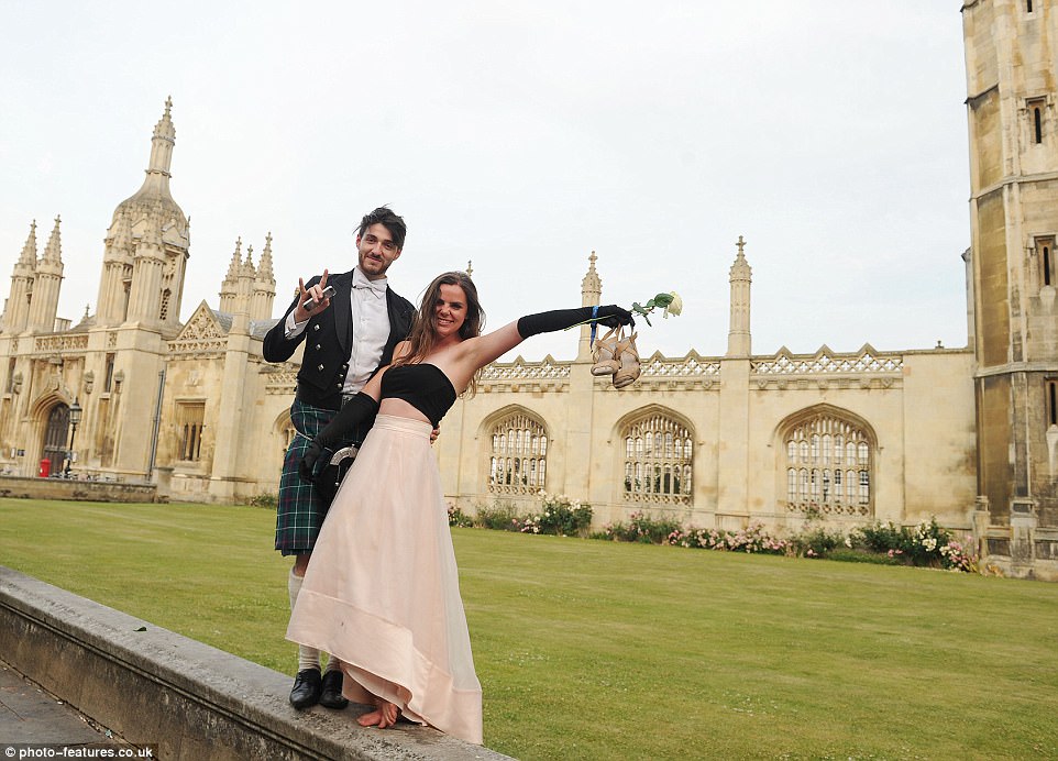 Getting into the party spirits: Guests kick off their heels as the sun comes up following a night of partying in Cambridge