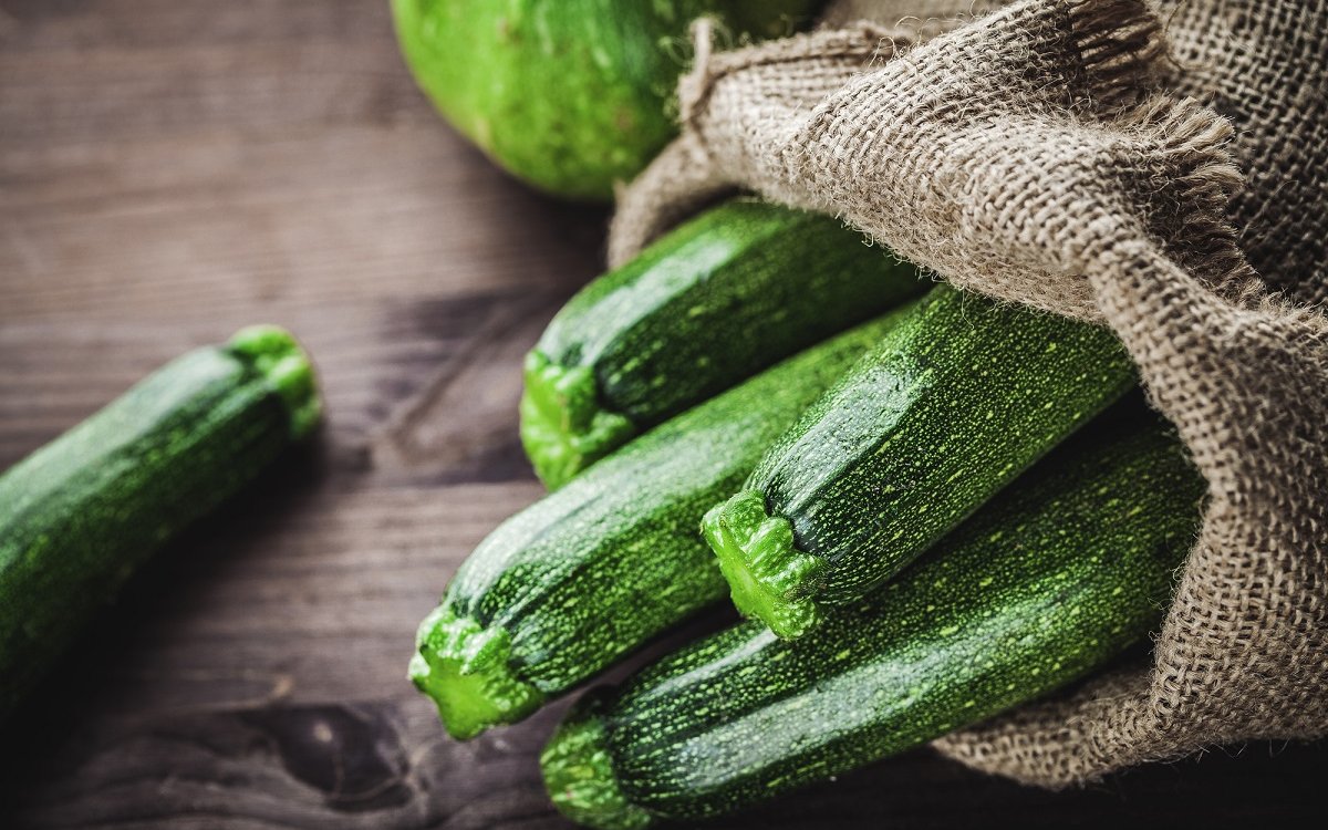 : fresh zucchini in a jute sack