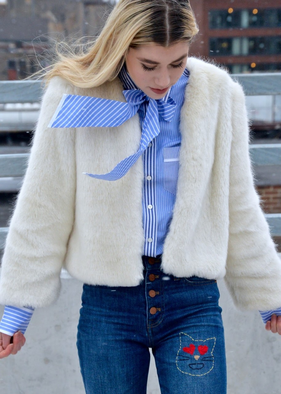 Woman walking through the snow in a Street Style Inspired winter outfit