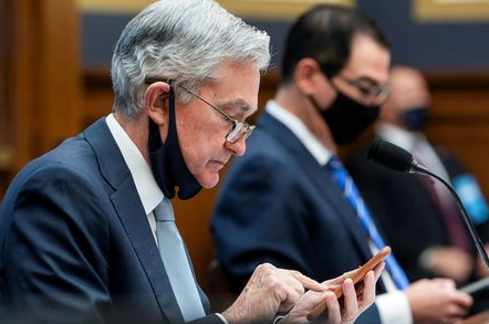 FILE PHOTO: Federal Reserve Chair Jerome Powell (L) and former Treasury Secretary Steven Mnuchin prepare to speak during a House Financial Services Committee hearing on "Oversight of the Treasury Department's and Federal Reserve's Pandemic Response" in the Rayburn House Office Building in Washington, U.S., December 2, 2020. Jim Lo Scalzo/Pool via REUTERS/File Photo FILE PHOTO: Federal Reserve Chair Jerome Powell (L) and former Treasury Secretary Steven Mnuchin prepare to speak during a House Financial Services Committee hearing on "Oversight of the Treasury Department's and Federal Reserve's Pandemic Response" in the Rayburn House Office Building in Washington, U.S., December 2, 2020. Jim Lo Scalzo/Pool via REUTERS/File Photo