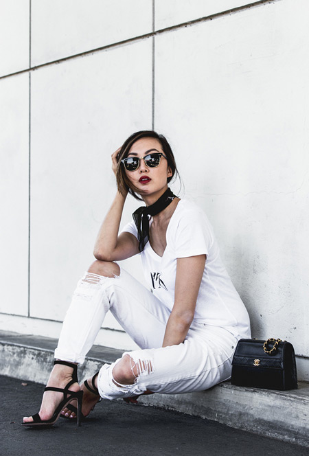 Модель в белых рваных брюках, футболка, босоножки