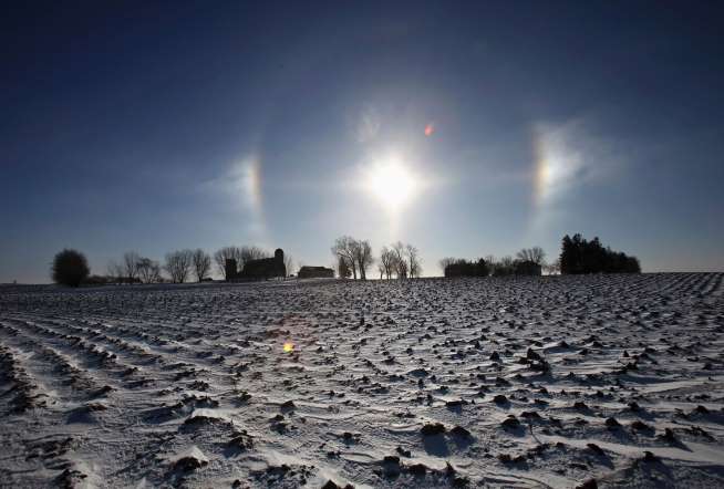A "sun dog" atmospheric phenomenon appears over a farm in southern Minnesota, on January 27, 2014.
