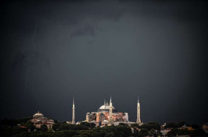 Clouds gather over the Hagia Sophia museum during a storm on August 7, 2014.